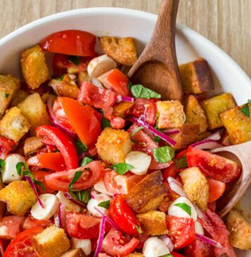Panzanella Salad tossed in a bowl garnished with basil